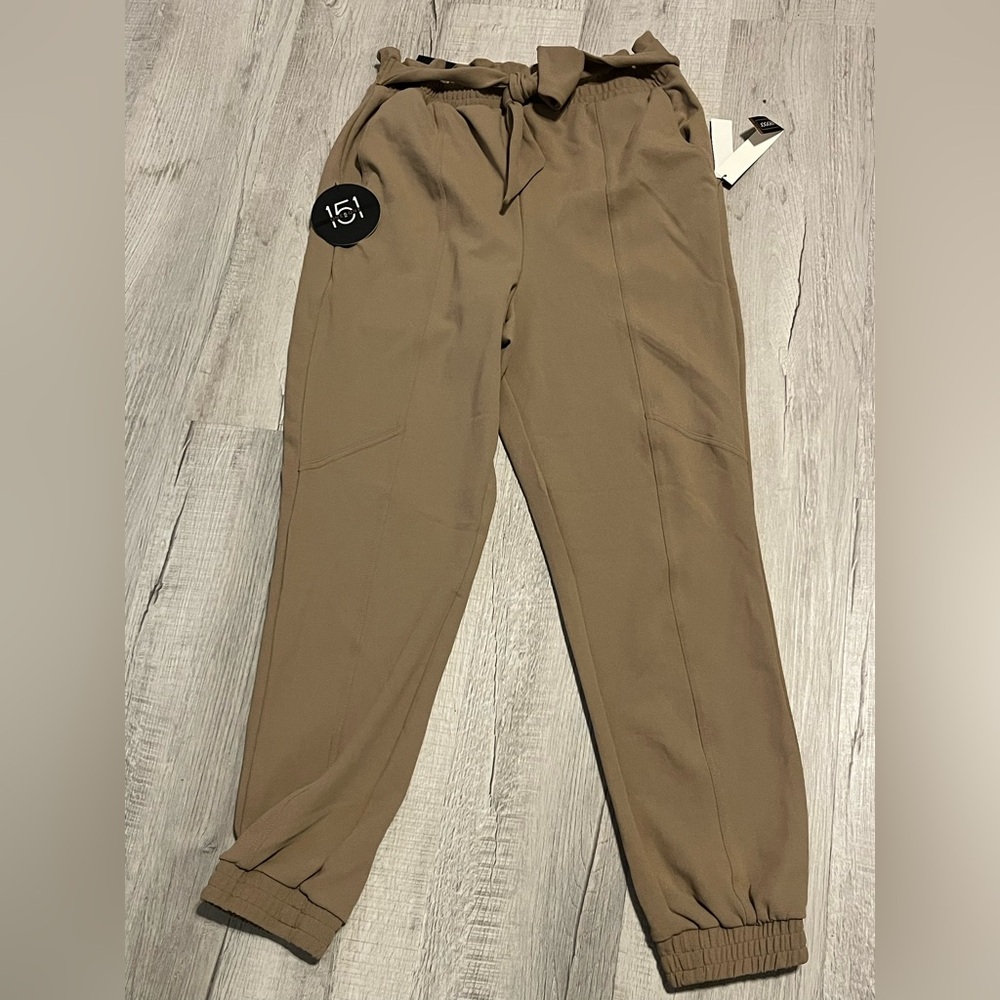 Tan color dressy pants has front now tie